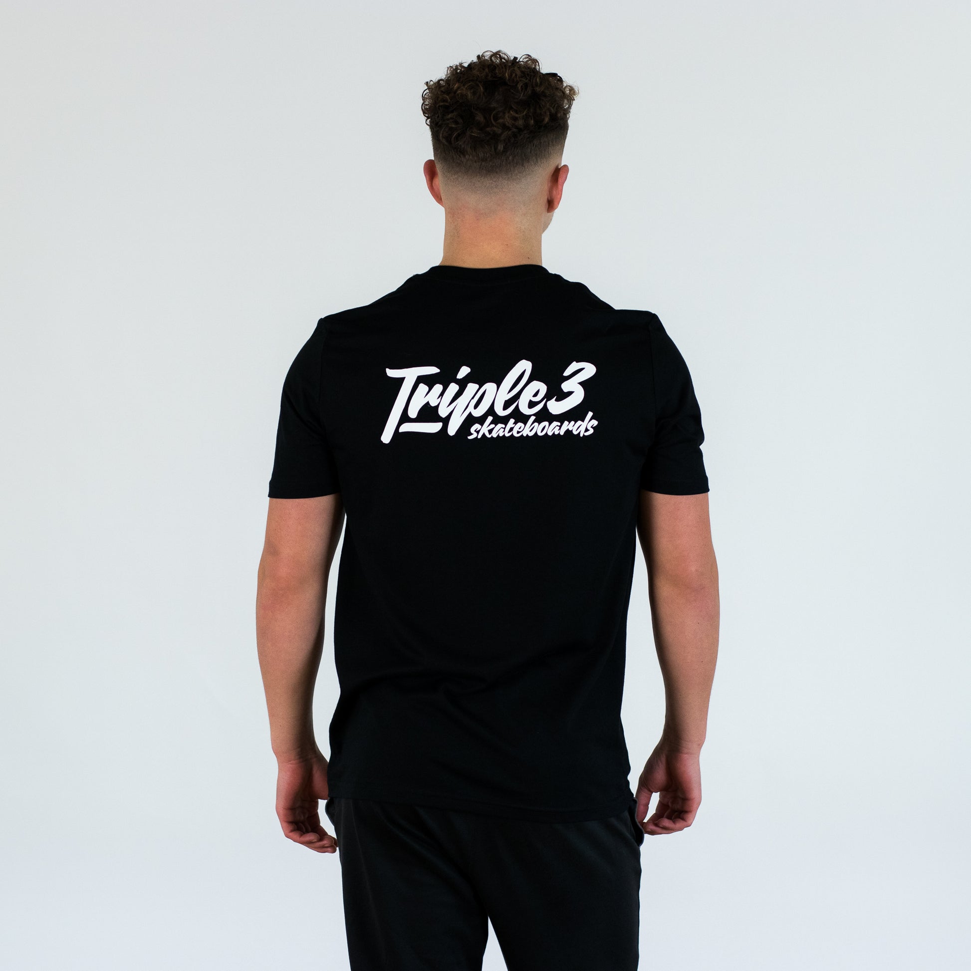 model wearing triple 3 skateboards t shirt