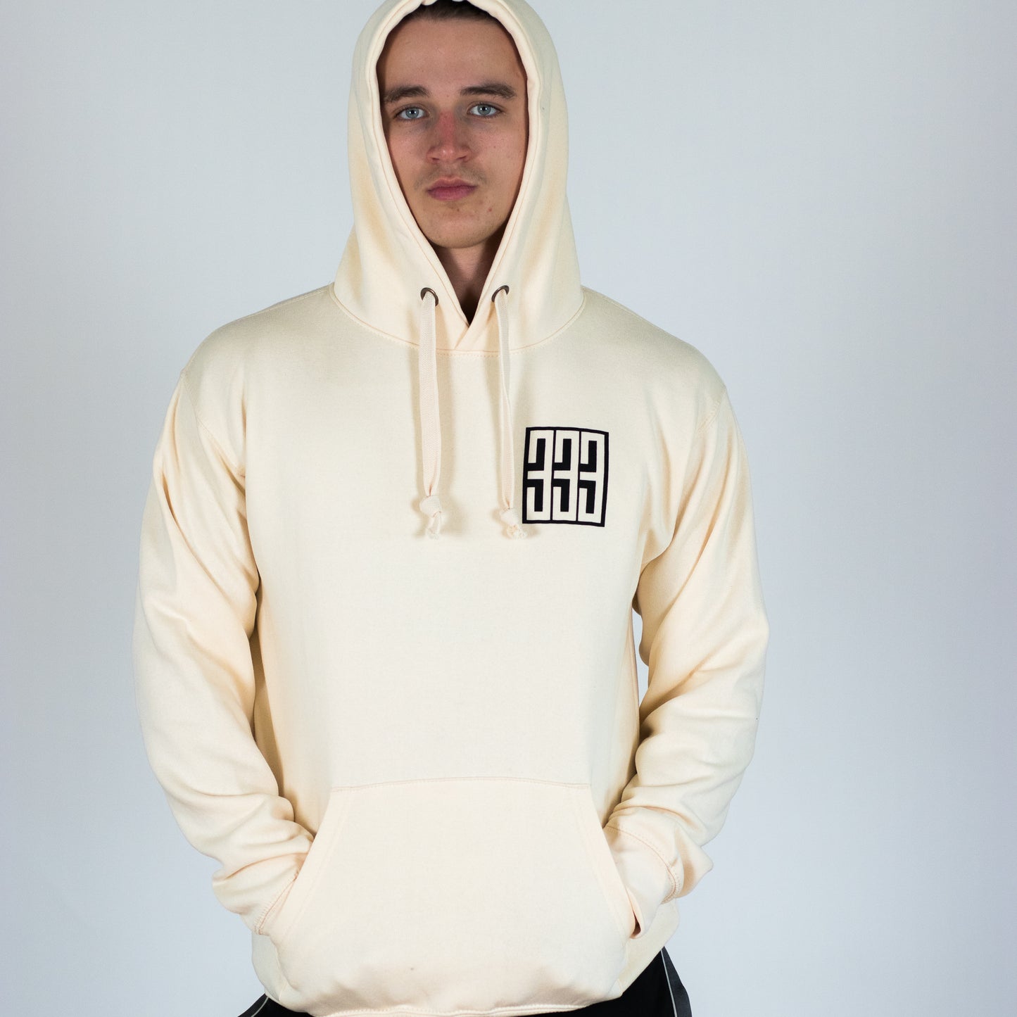 model wearing 333 boxed hoody in ivory from front