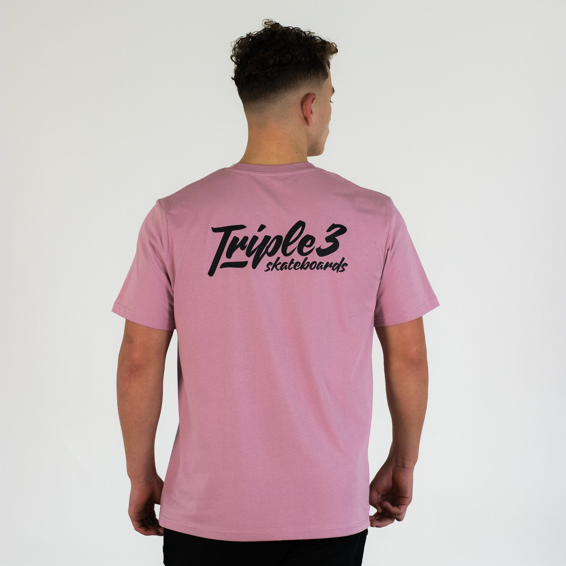 pink triple 3 skateboards t shirt worn by model
