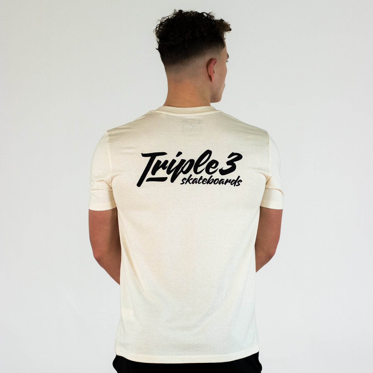 model wearing natural coloured triple 3 skateboard t shirt