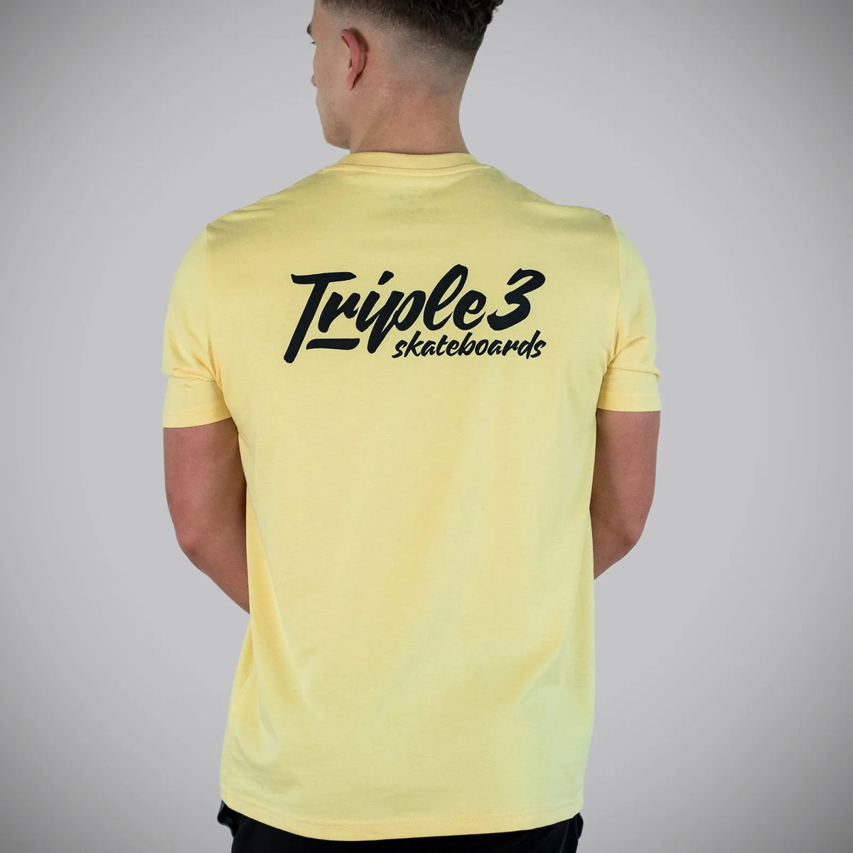 Yellow Triple 3 Skateboards T-Shirt model in studio